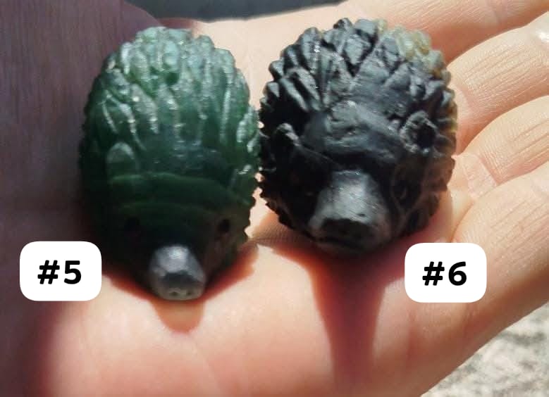 Hedgehog sculptures made from various natural stones.